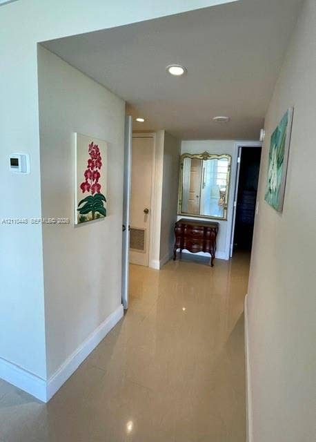 2780 NE 183rd Street, #517, Aventura, FL 33160 Hallway featuring polished tile flooring, recessed ceiling lighting, and a neutral color palette