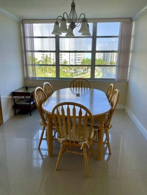 2780 NE 183rd Street, #517, Aventura, FL 33160 Large window featuring a metal frame, polished tile flooring, and an overhead multi-arm chandelier