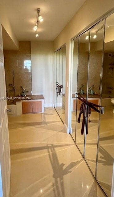 2780 NE 183rd Street, #517, Aventura, FL 33160 Light-toned tile flooring, built-in cabinetry with stone-finish countertops, full-length mirrored closet doors, and adjustable track lighting