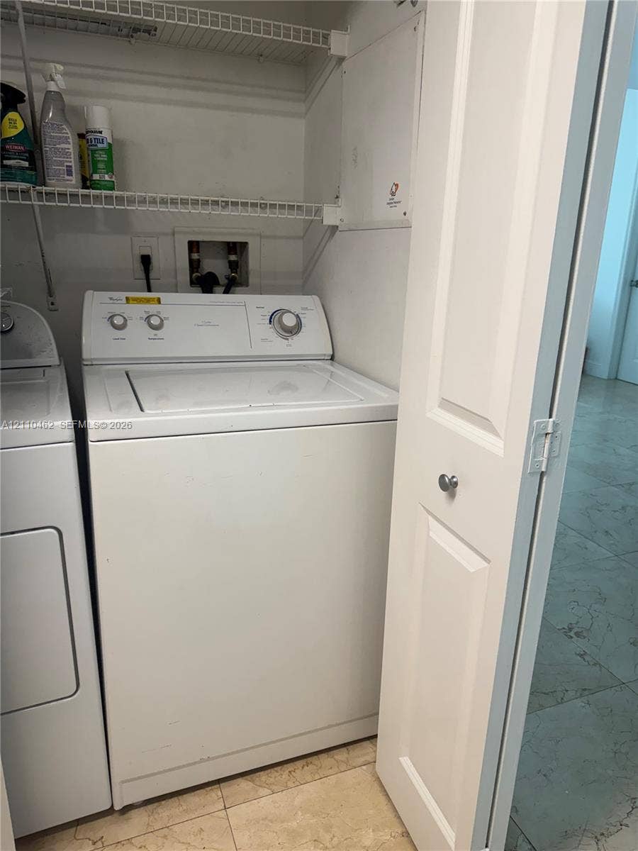 Laundry closet featuring wire shelving and bifold doors