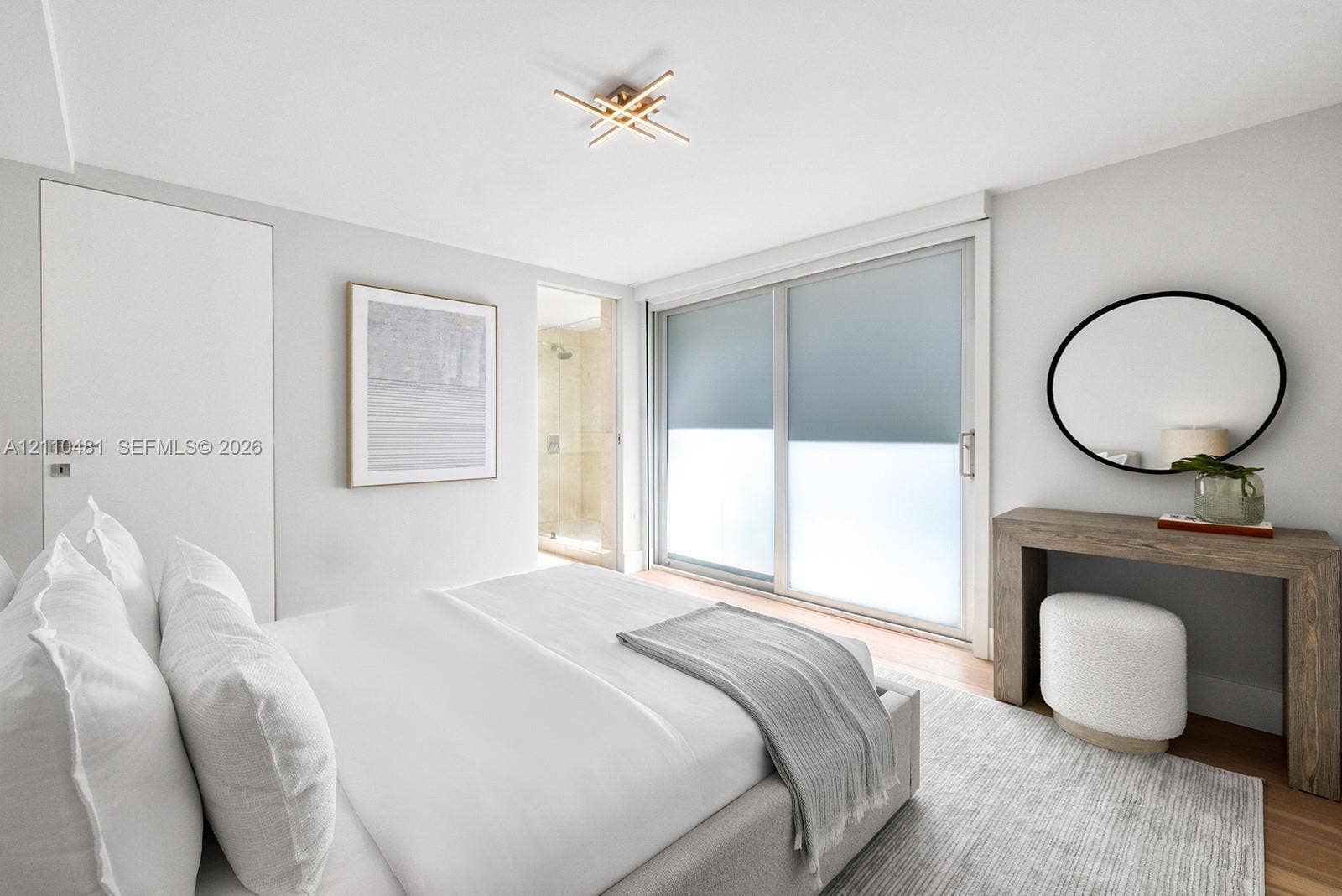 234 Washington Avenue, #D, Miami Beach, FL 33139 Sliding glass door, flush-mount multi-arm geometric light fixture, wood-finish flooring, and crisp neutral wall palette