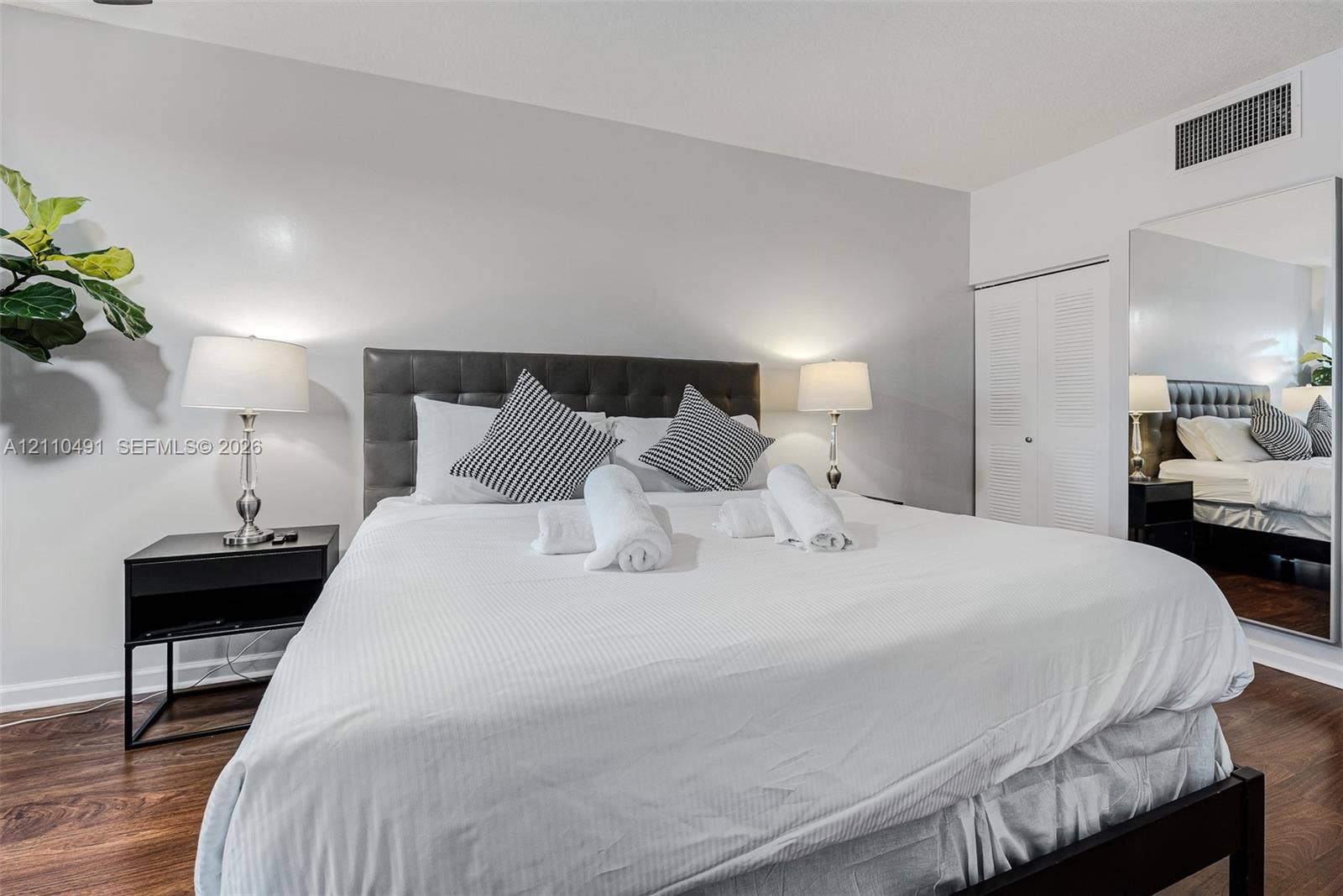 3339 Virginia Street, #136, Miami, Miami, FL 33133 Spacious interior featuring wood-finish flooring, neutral wall paint, and a built-in closet with louvered doors