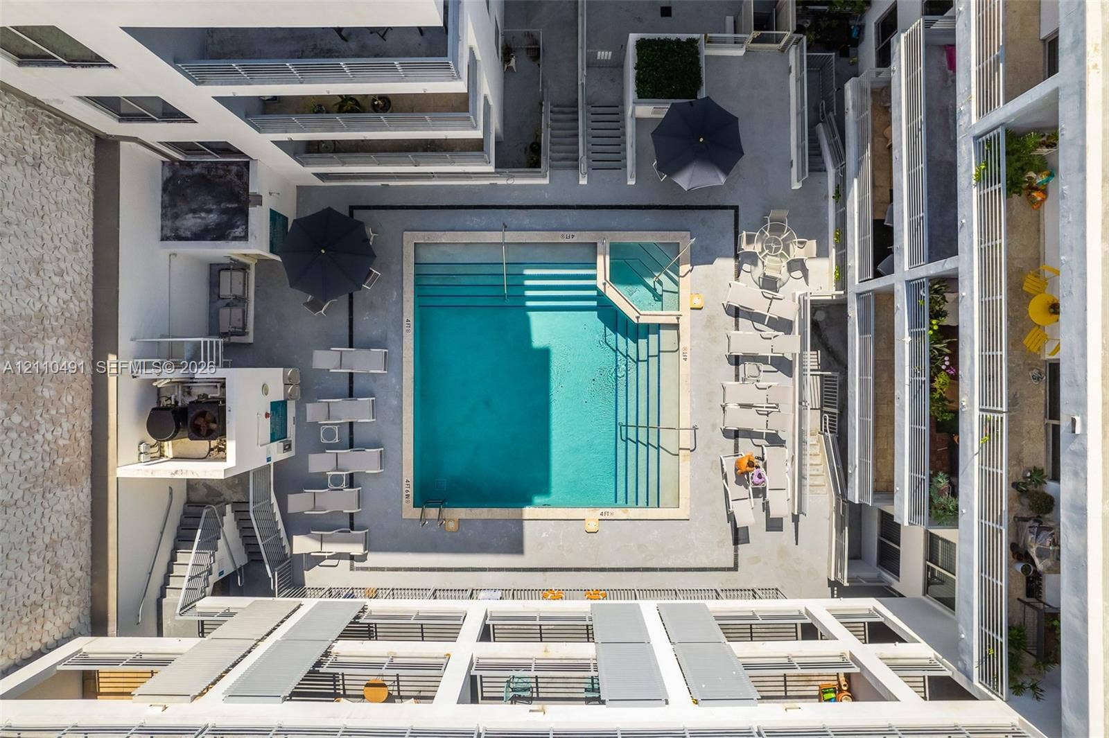 3339 Virginia Street, #136, Miami, Miami, FL 33133 Courtyard featuring an in-ground swimming pool with integrated tiered entry steps and a surrounding concrete deck