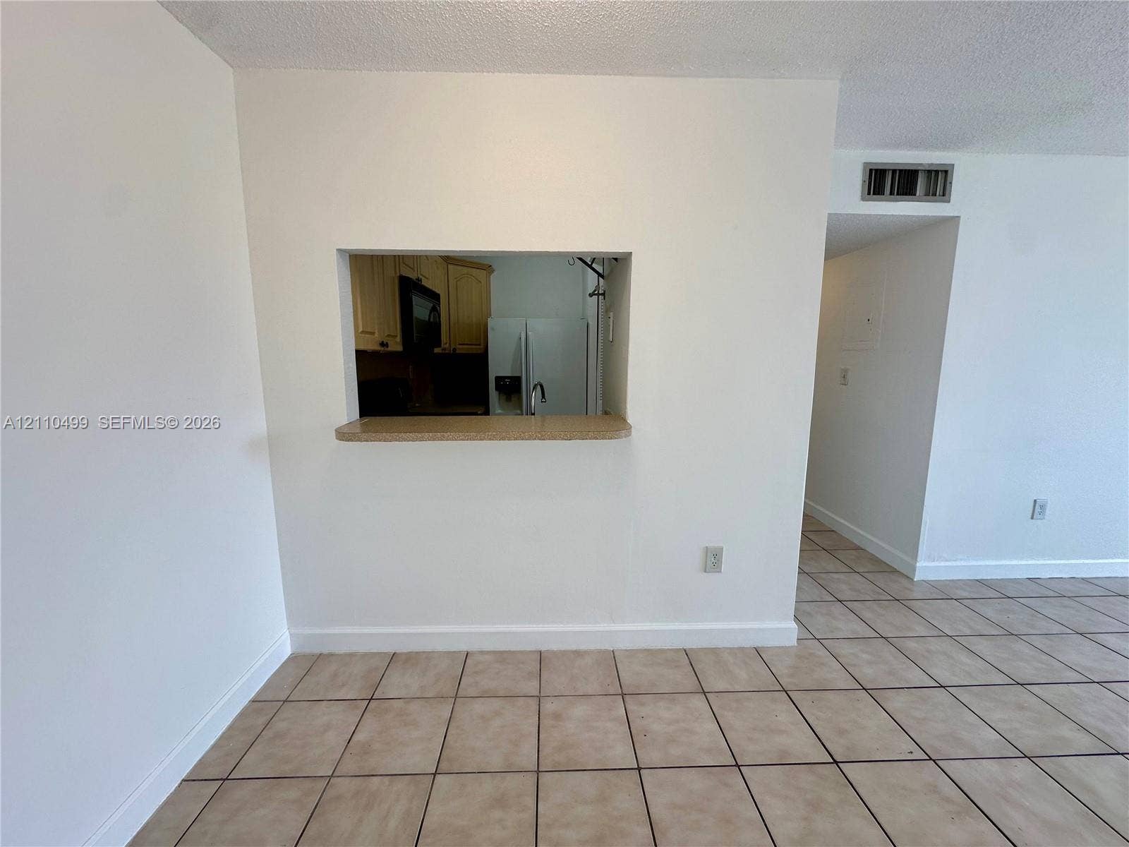 8145 NW 7th Street, #308, Miami, Miami, FL 33126 Interior space featuring ceramic tile flooring and a service pass-through opening with a countertop