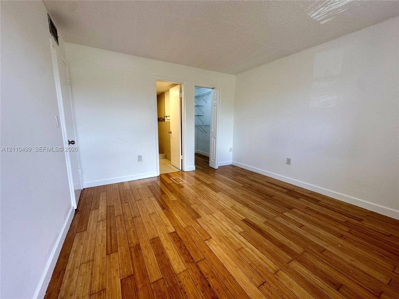 8145 NW 7th Street, #308, Miami, Miami, FL 33126 Wood-finish flooring, two interior doors, and a built-in reach-in closet