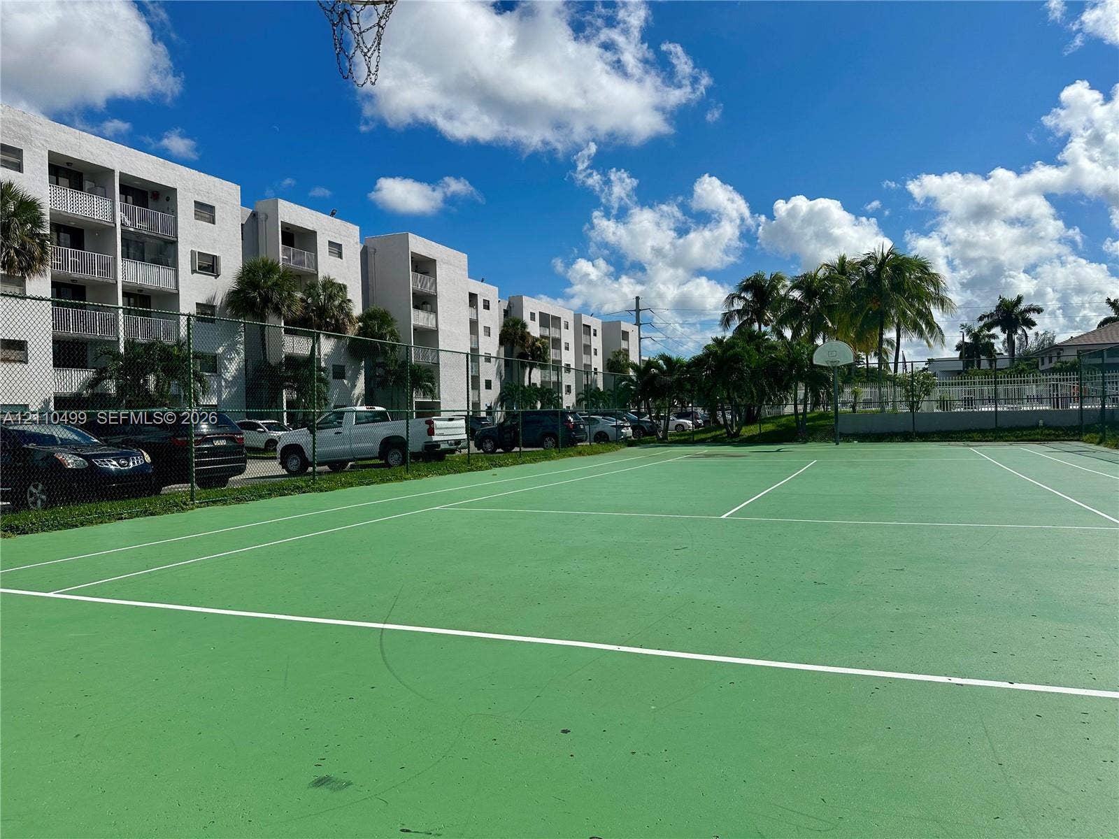 8145 NW 7th Street, #308, Miami, Miami, FL 33126 Outdoor recreation area featuring a paved multi-purpose court, chain-link perimeter fencing, and basketball goal