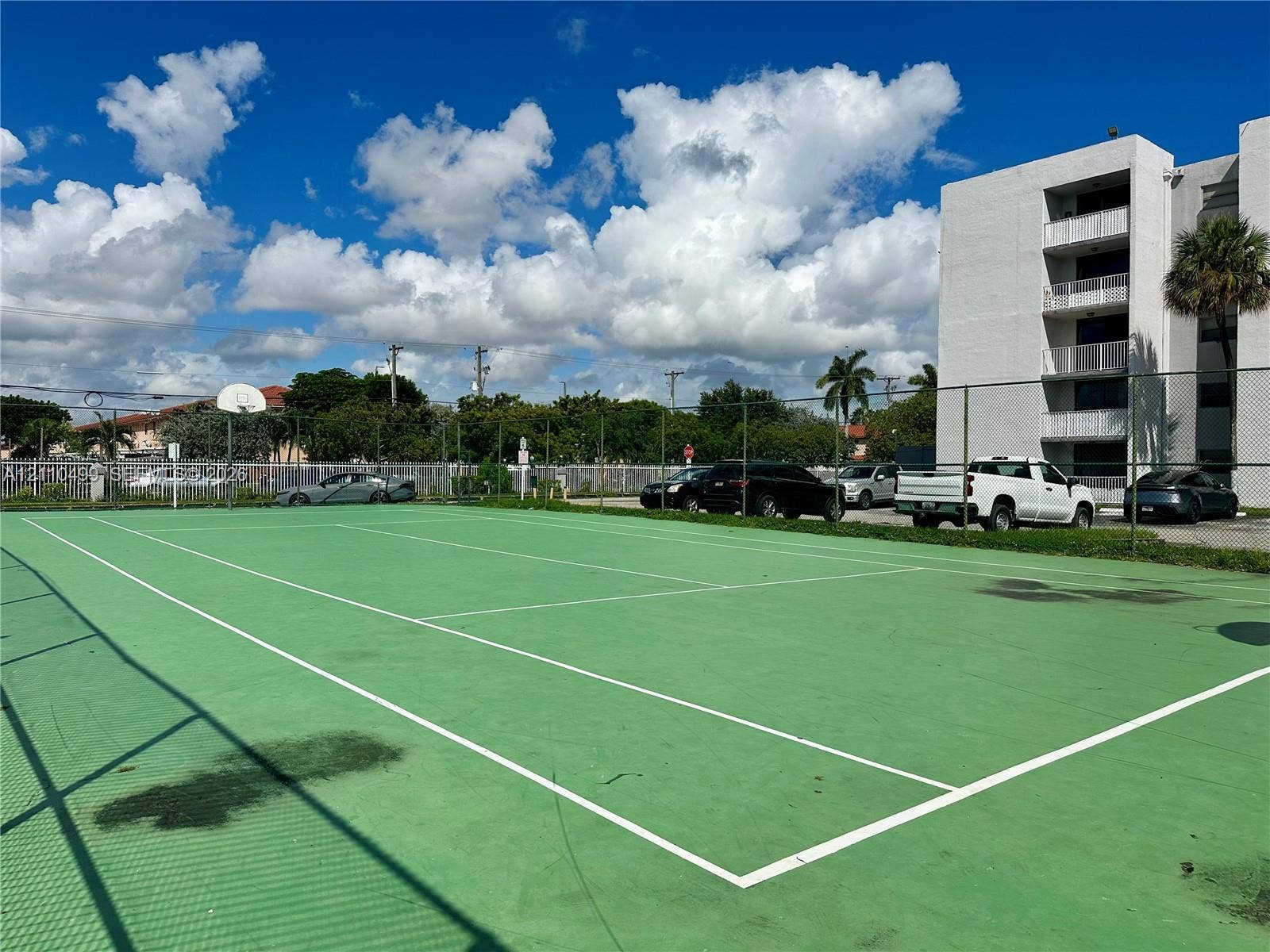 8145 NW 7th Street, #308, Miami, Miami, FL 33126 Recreational court featuring a fenced perimeter, hard-surface playing area, and integrated basketball hoop