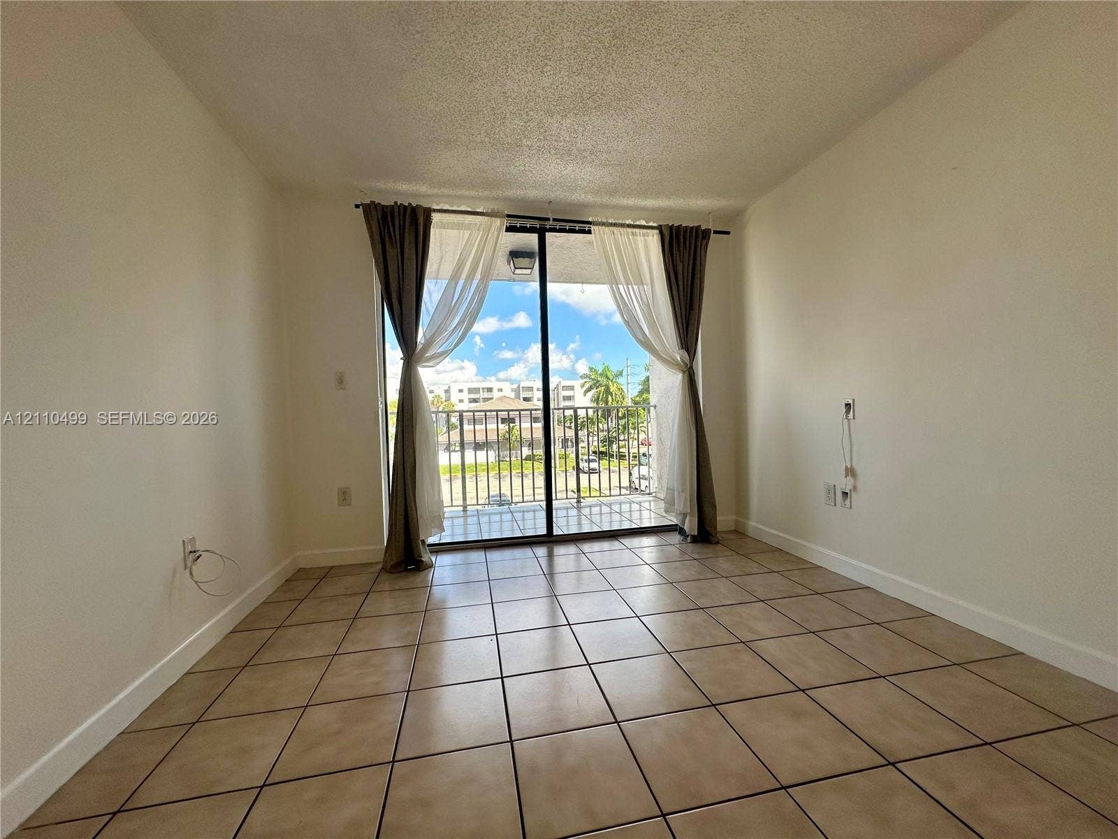 8145 NW 7th Street, #308, Miami, Miami, FL 33126 Ceramic tile flooring, sliding glass door, and private balcony with metal railing