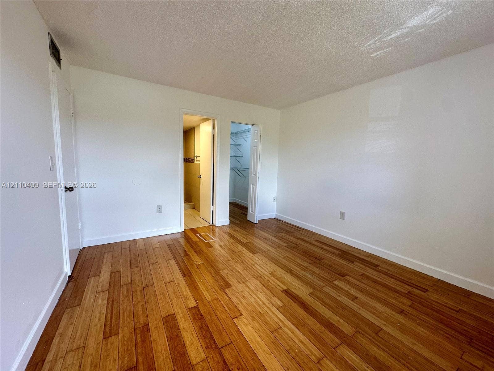 8145 NW 7th Street, #308, Miami, Miami, FL 33126 Wood-finish flooring throughout, smooth-texture ceiling, and a built-in closet with wire shelving