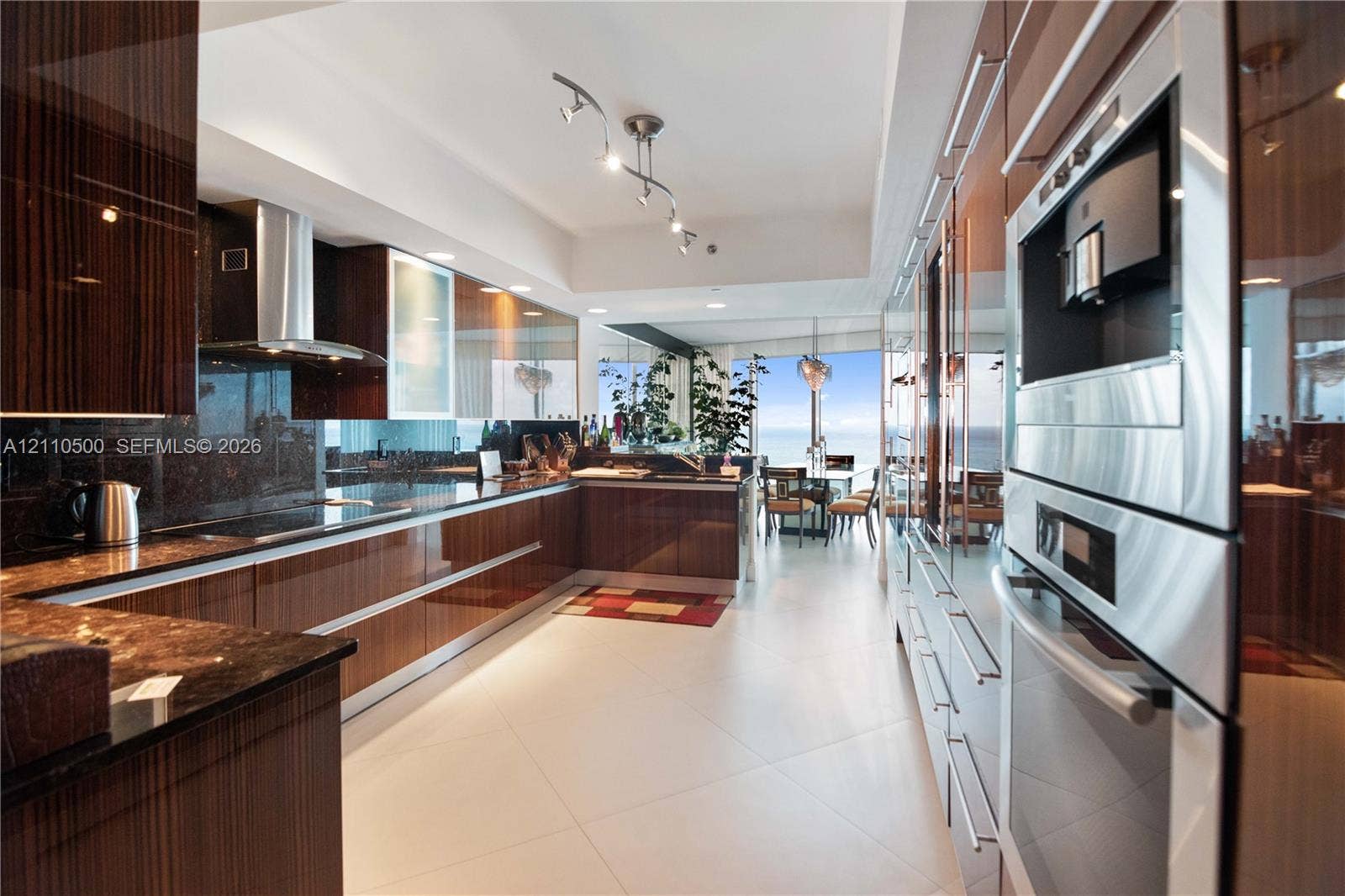 2711 S Ocean Drive, #2205, Hollywood, Hollywood, FL 33019 High-gloss cabinetry, stone countertops, built-in stainless steel double wall ovens, stainless steel range hood, and tile flooring