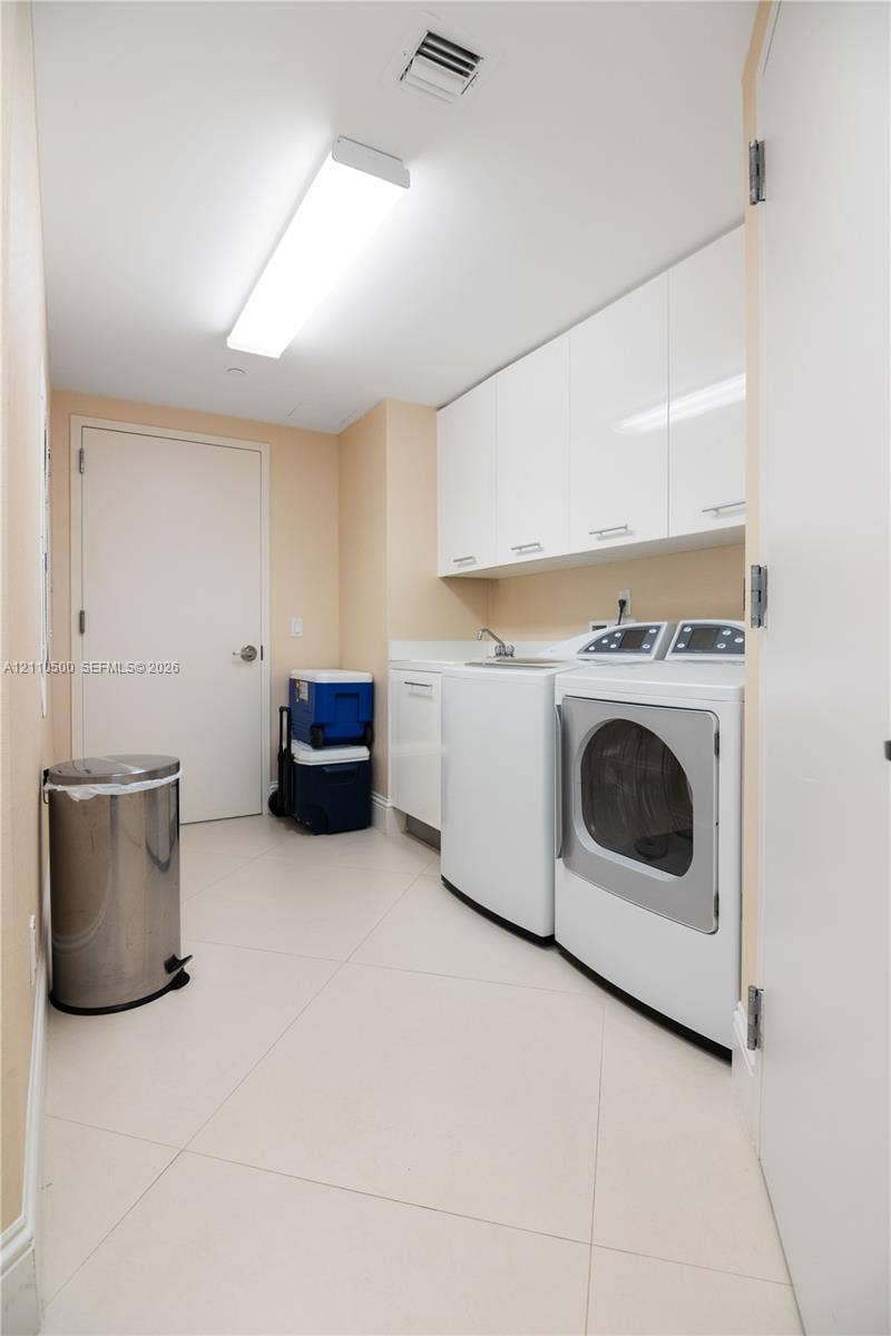 2711 S Ocean Drive, #2205, Hollywood, Hollywood, FL 33019 Laundry area featuring large-format tile flooring, white cabinetry, integrated countertop with sink, and recessed ceiling lighting