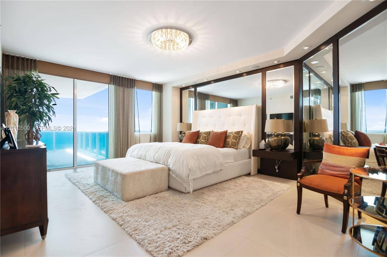 2711 S Ocean Drive, #2205, Hollywood, Hollywood, FL 33019 Full-height floor-to-ceiling glass sliding doors, expansive mirrored wall panels, polished tile flooring, recessed ceiling lighting, and integrated dark-tone floating nightstands