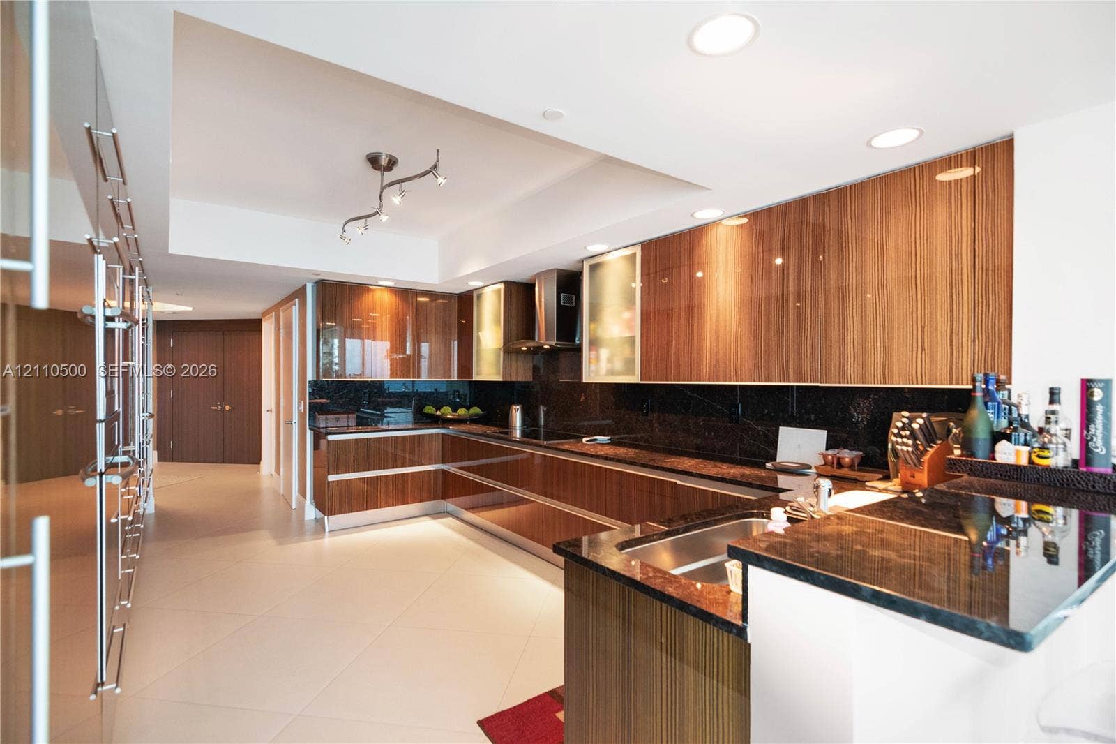 2711 S Ocean Drive, #2205, Hollywood, Hollywood, FL 33019 Gourmet kitchen featuring high-gloss wood-finish cabinetry, dark stone countertops, stainless steel appliances, recessed ceiling lighting, and large-format tile flooring