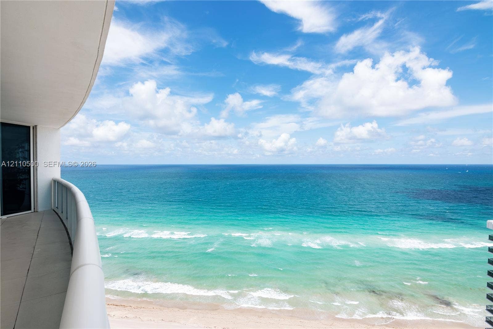 2711 S Ocean Drive, #2205, Hollywood, Hollywood, FL 33019 Covered balcony featuring concrete flooring and a glass-paneled railing overlooking the ocean