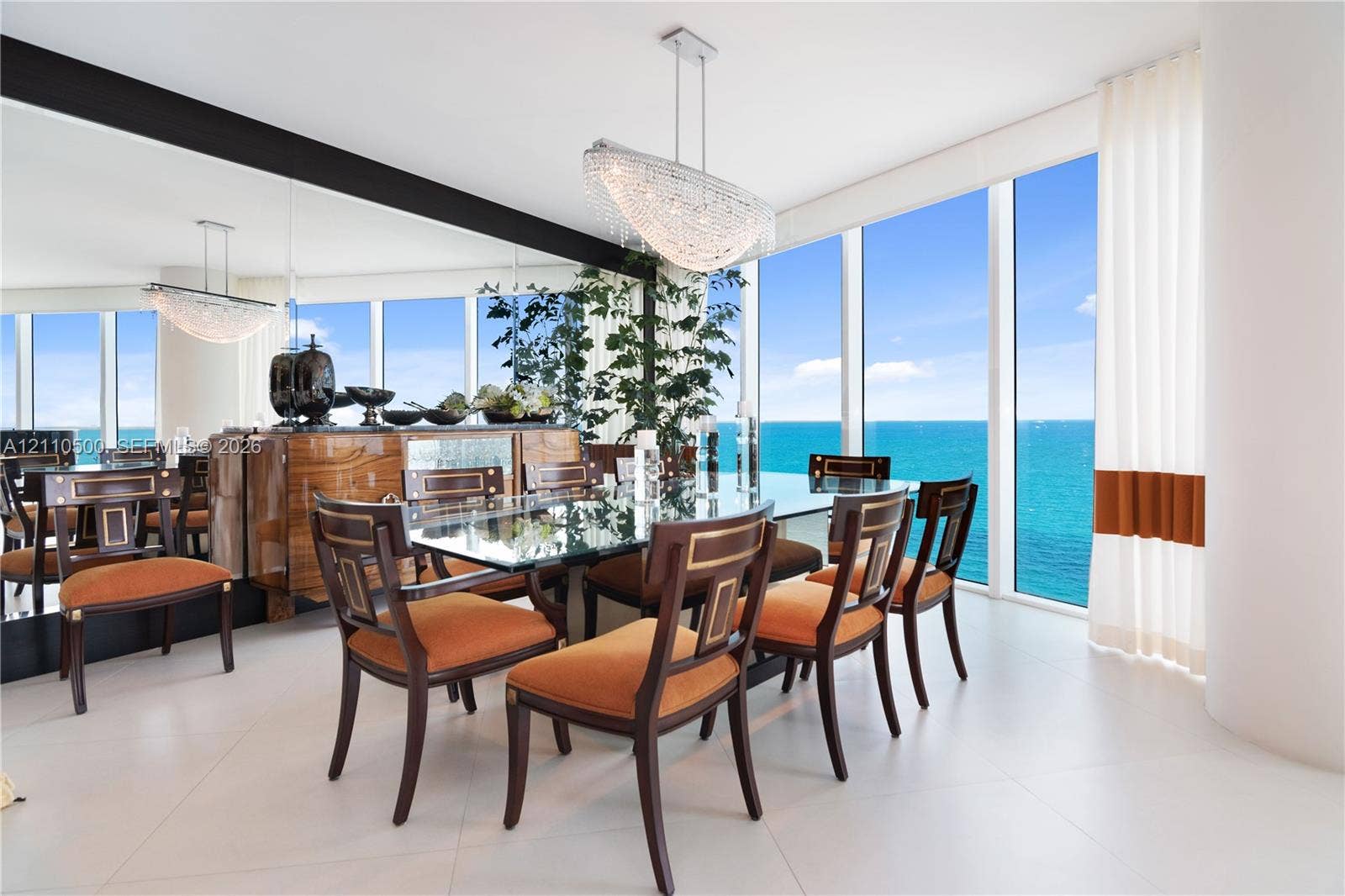 2711 S Ocean Drive, #2205, Hollywood, Hollywood, FL 33019 Floor-to-ceiling windows, large-format tile flooring, expansive wall mirror, and contemporary multi-tiered crystal pendant lighting