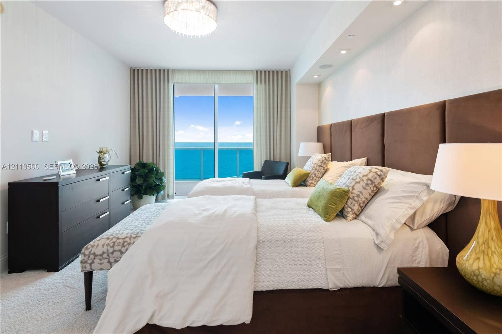 2711 S Ocean Drive, #2205, Hollywood, Hollywood, FL 33019 Floor-to-ceiling sliding glass doors, built-in recessed ceiling lighting, upholstered panel headboard, and neutral wall-to-wall carpeting