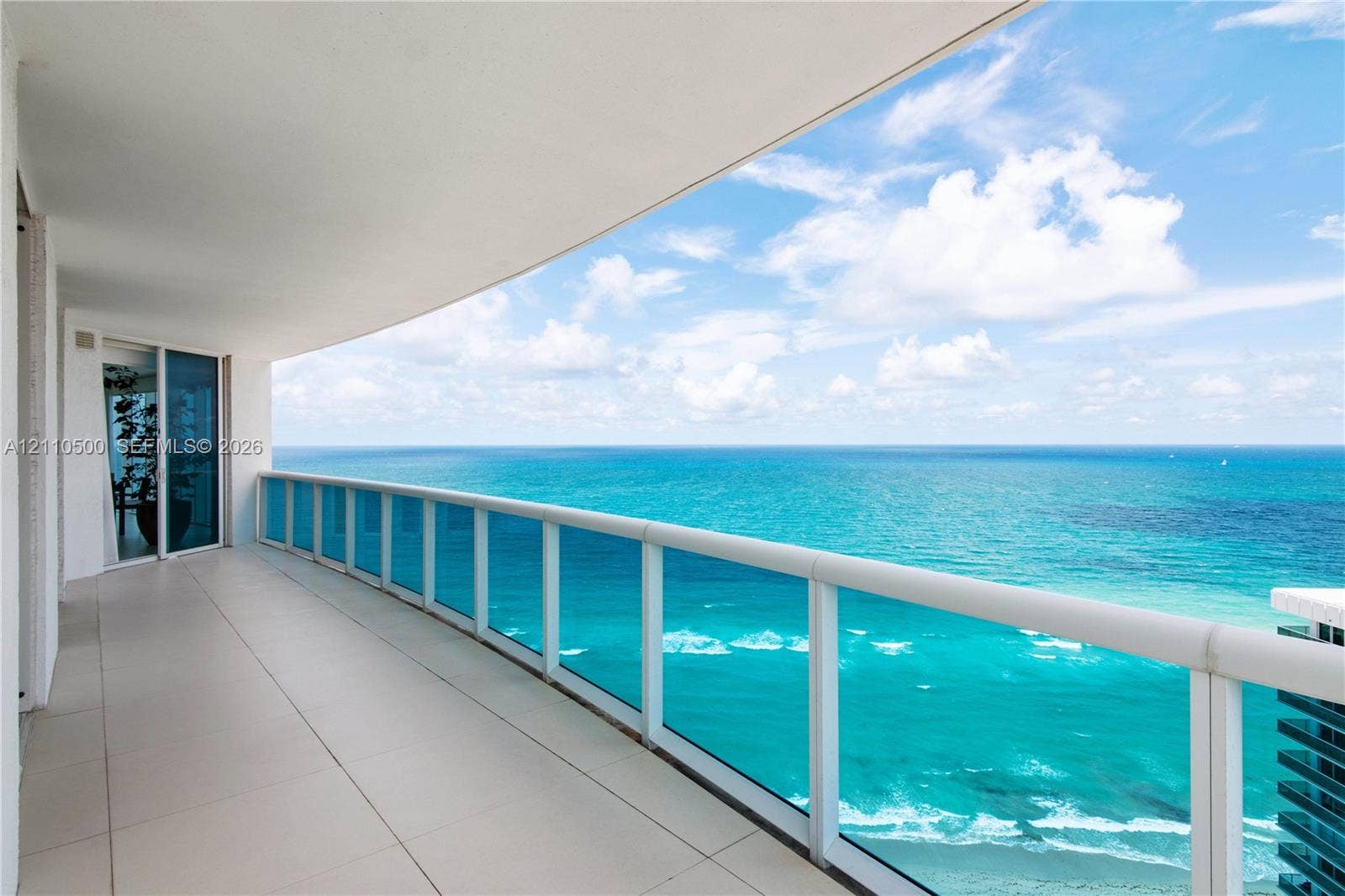 2711 S Ocean Drive, #2205, Hollywood, Hollywood, FL 33019 Curved wrap-around balcony with oversized tile flooring, full-height glass railings, and expansive ocean frontage