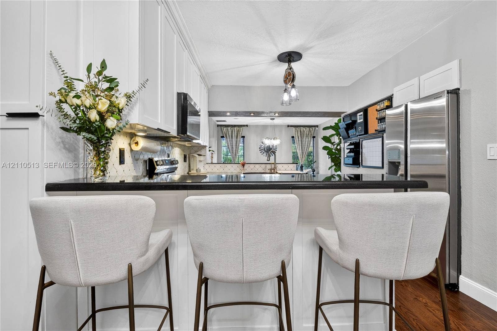 6520 SW 16th Terrace, West Miami, FL 33155 Kitchen featuring white shaker-style cabinetry, dark stone countertops, stainless steel appliances, and wood-finish flooring