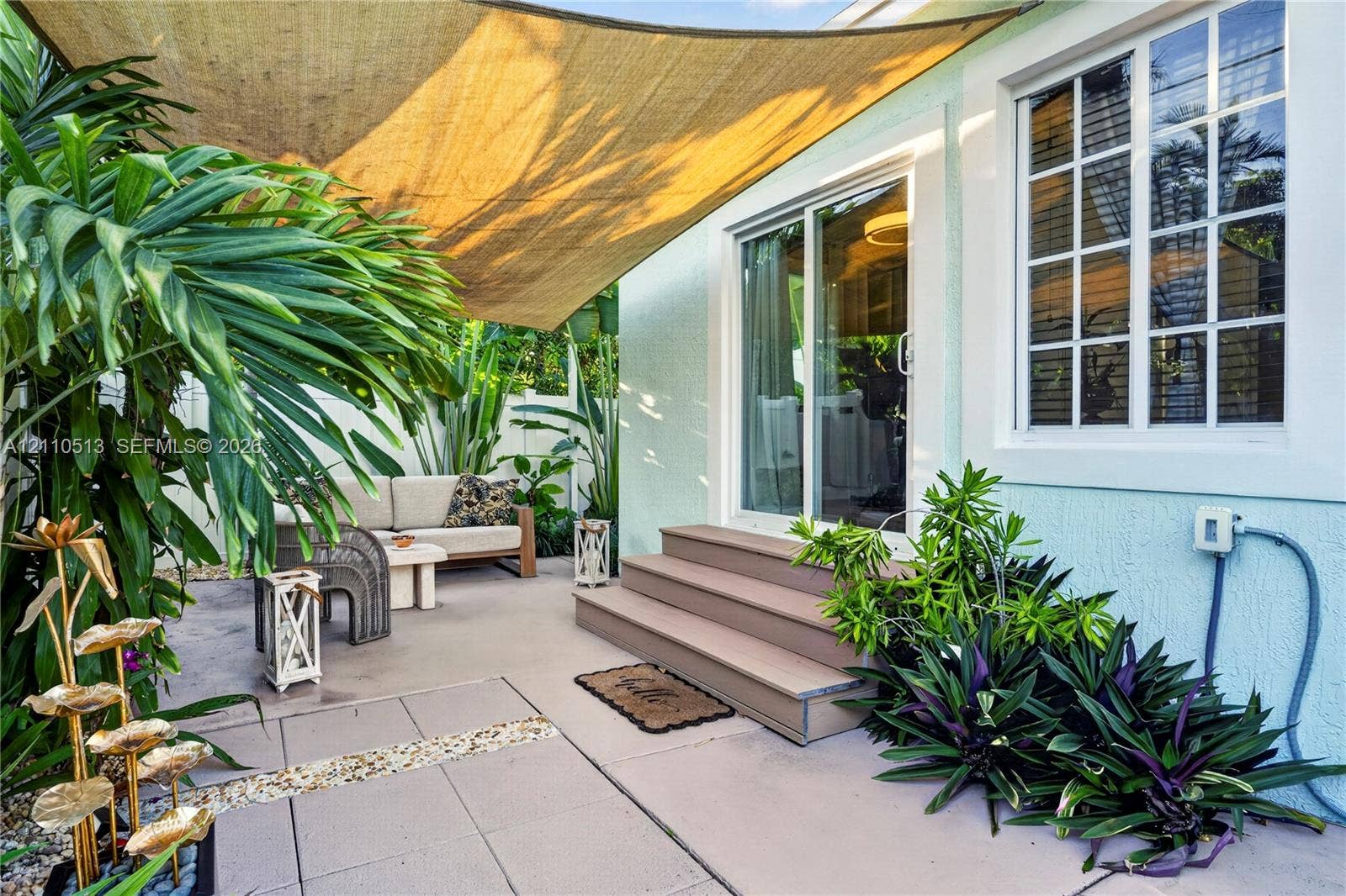 6520 SW 16th Terrace, West Miami, FL 33155 Patio space featuring concrete pavers, multi-pane window, sliding glass door, and stepped exterior platform