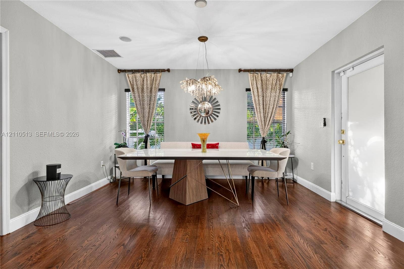 6520 SW 16th Terrace, West Miami, FL 33155 Wood-finish flooring, recessed ceiling lighting, a multi-tiered crystal chandelier, and dual windows