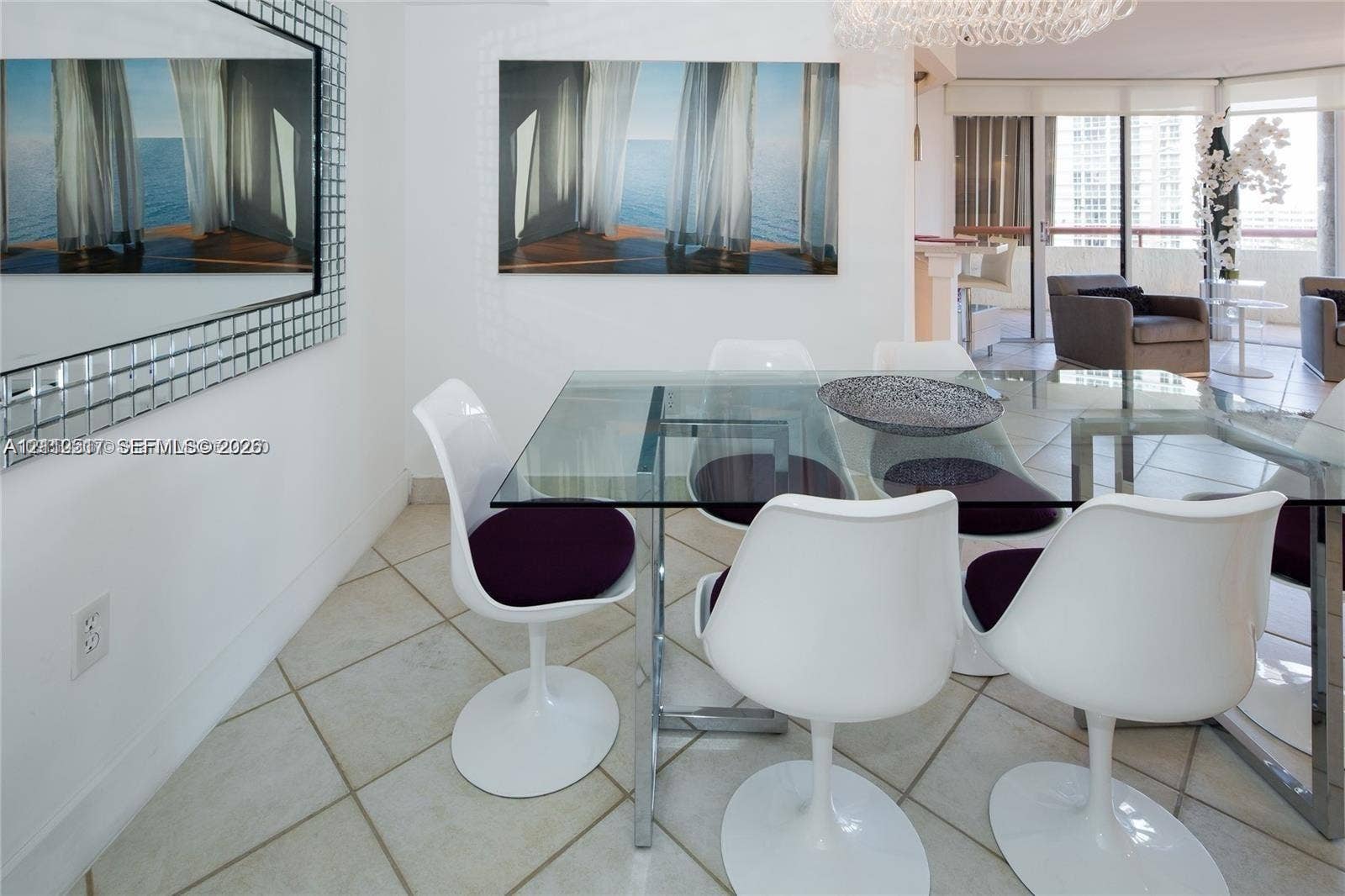 Large-format grid mirror with a metallic frame, expansive glass-paned sliding doors, polished tile flooring, and a contemporary crystal chandelier