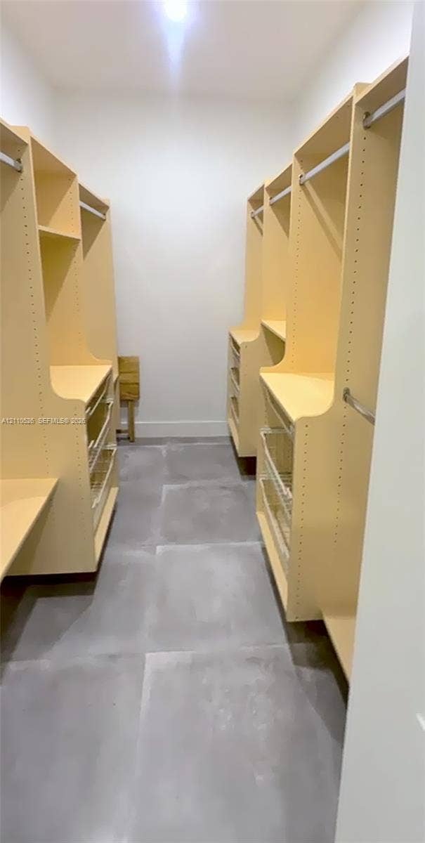 15677 SW 20 Street, #B, Miami, Miami, FL 33185 Customized storage system featuring built-in shelving, hanging rods, and integrated pull-out drawers, complemented by large-format tile flooring