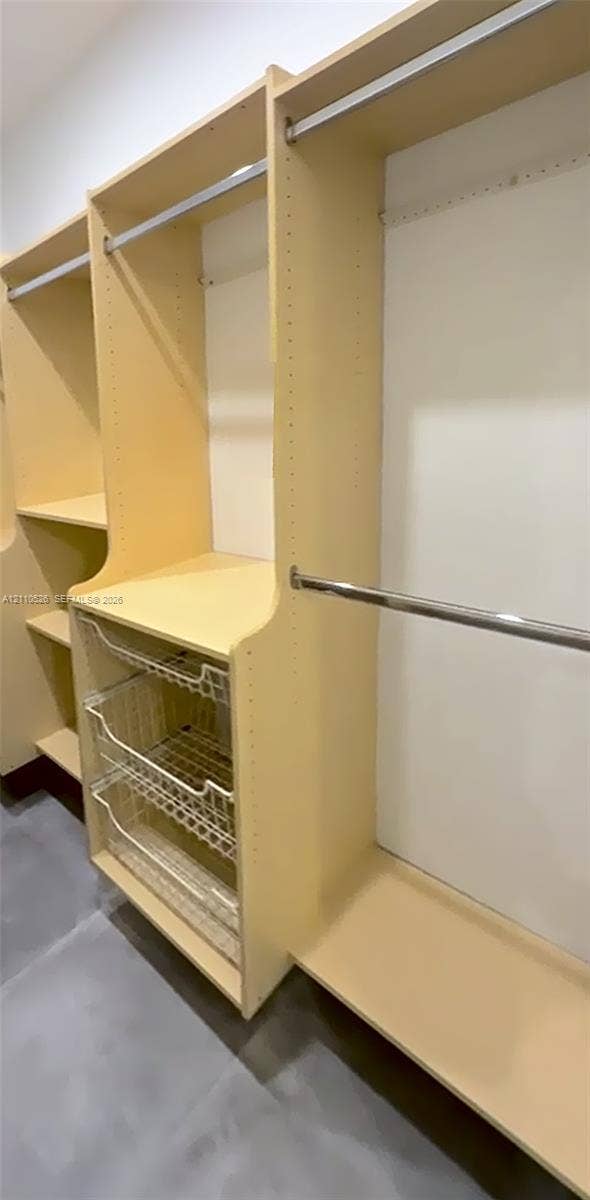 15677 SW 20 Street, #B, Miami, Miami, FL 33185 Custom closet system featuring light-finish laminate shelving, adjustable hanging rods, and integrated wire storage drawers