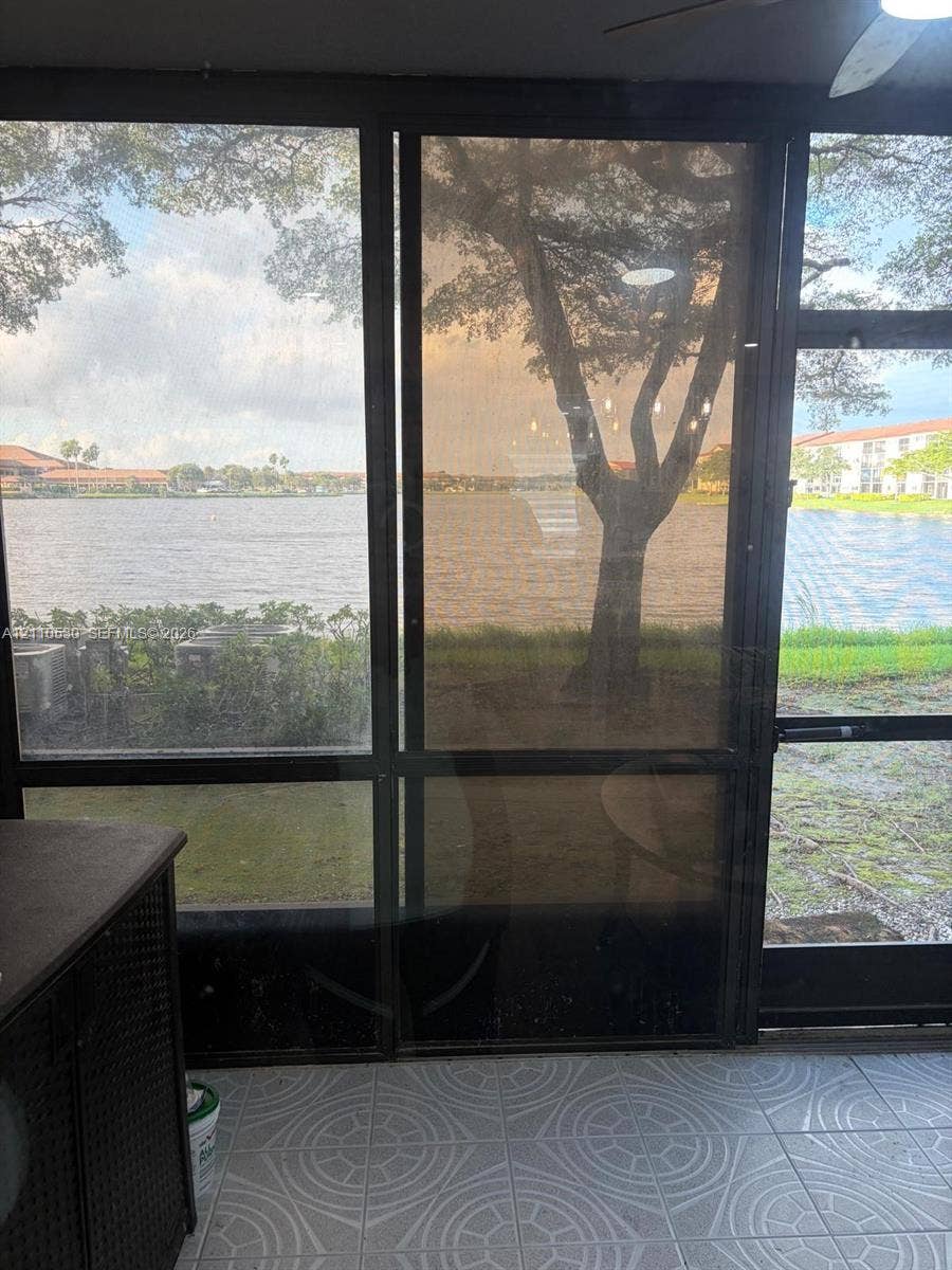 13255 SW 16th Court, #K112, Pembroke Pines, FL 33027 Screened-in patio with geometric tile flooring and full-height metal-framed screening
