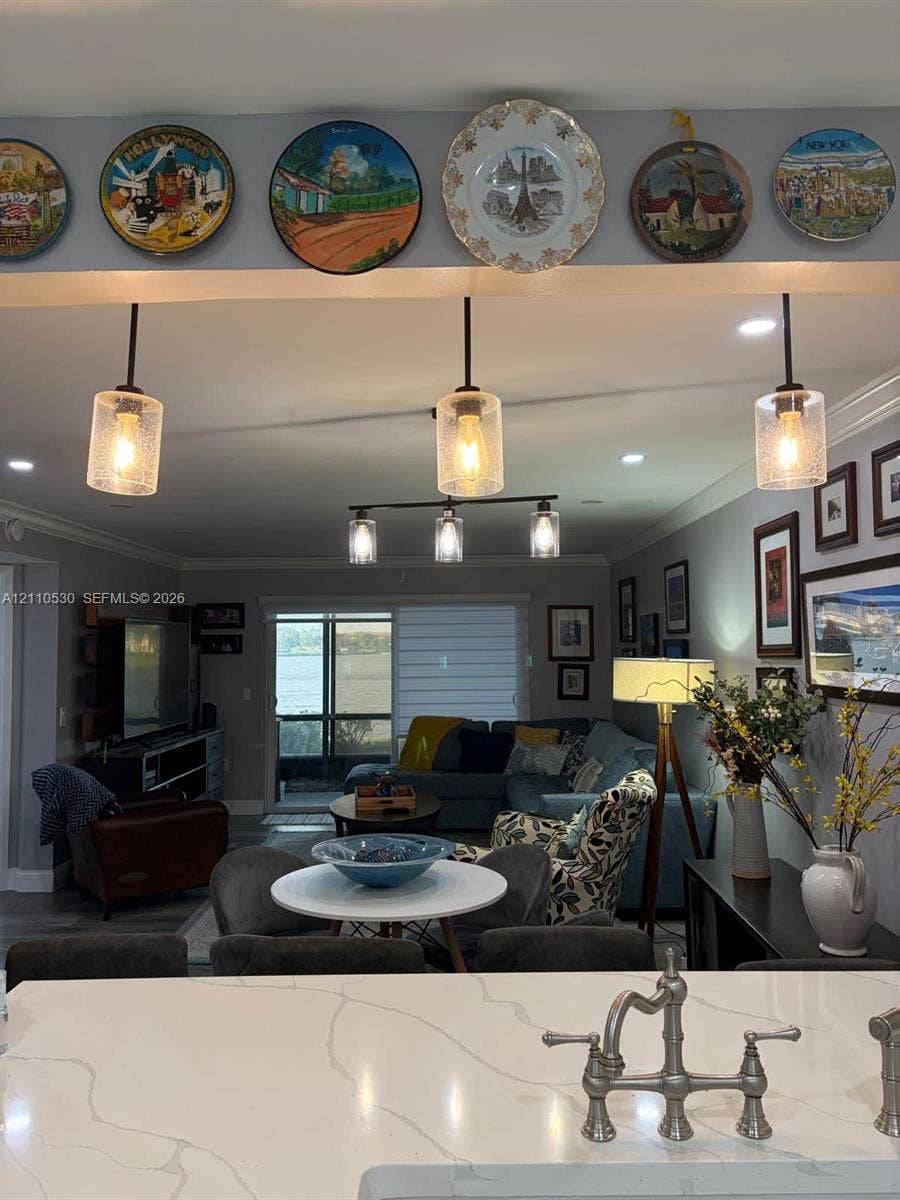 13255 SW 16th Court, #K112, Pembroke Pines, FL 33027 Quartz countertop featuring a bridge-style faucet, complemented by recessed lighting and tiered pendant fixtures