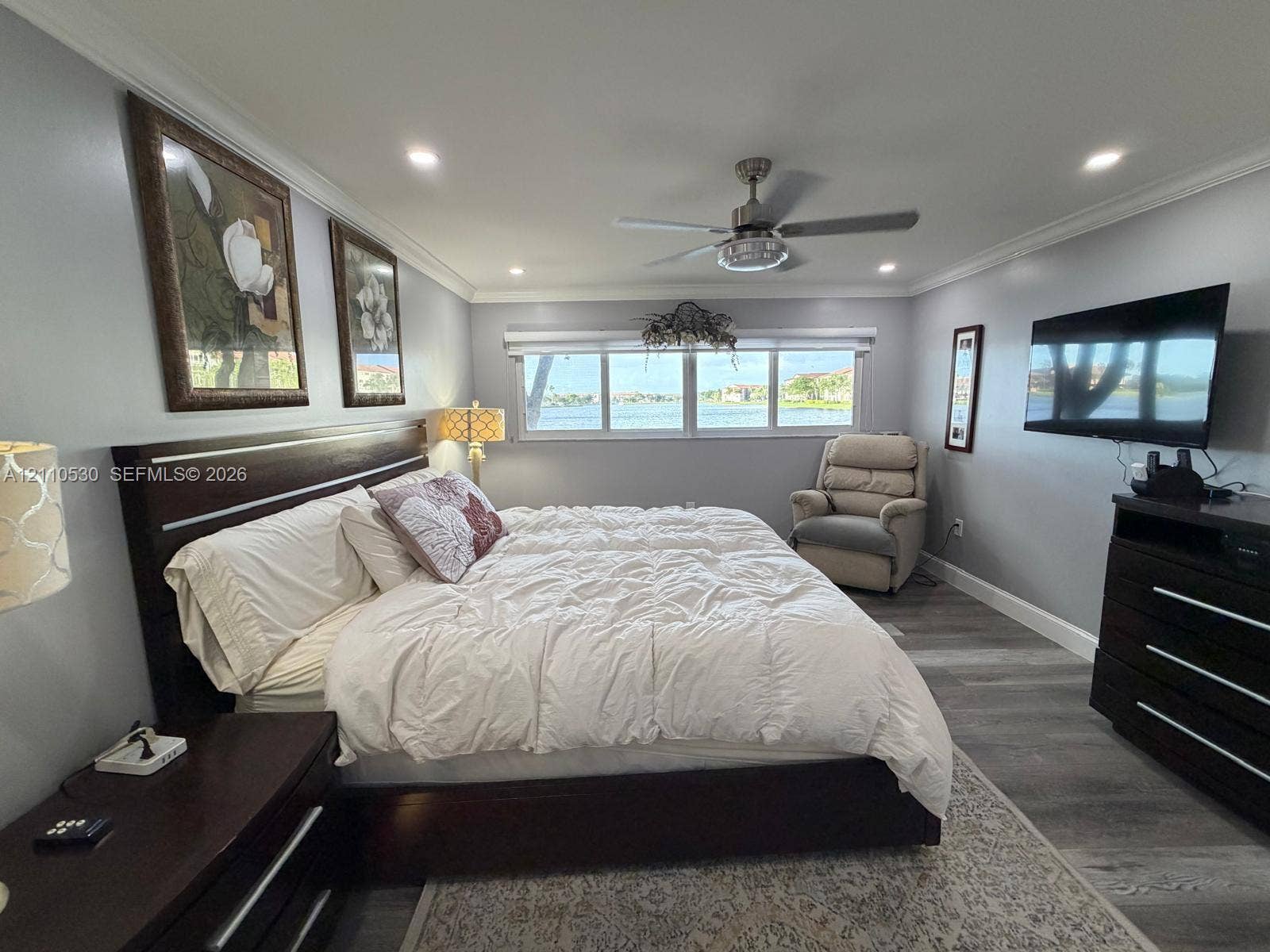 13255 SW 16th Court, #K112, Pembroke Pines, FL 33027 Wood-finish flooring, recessed lighting, crown molding, ceiling fan, and waterfront window exposure