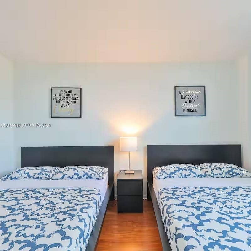 Room featuring smooth-finish walls and wood-finish flooring