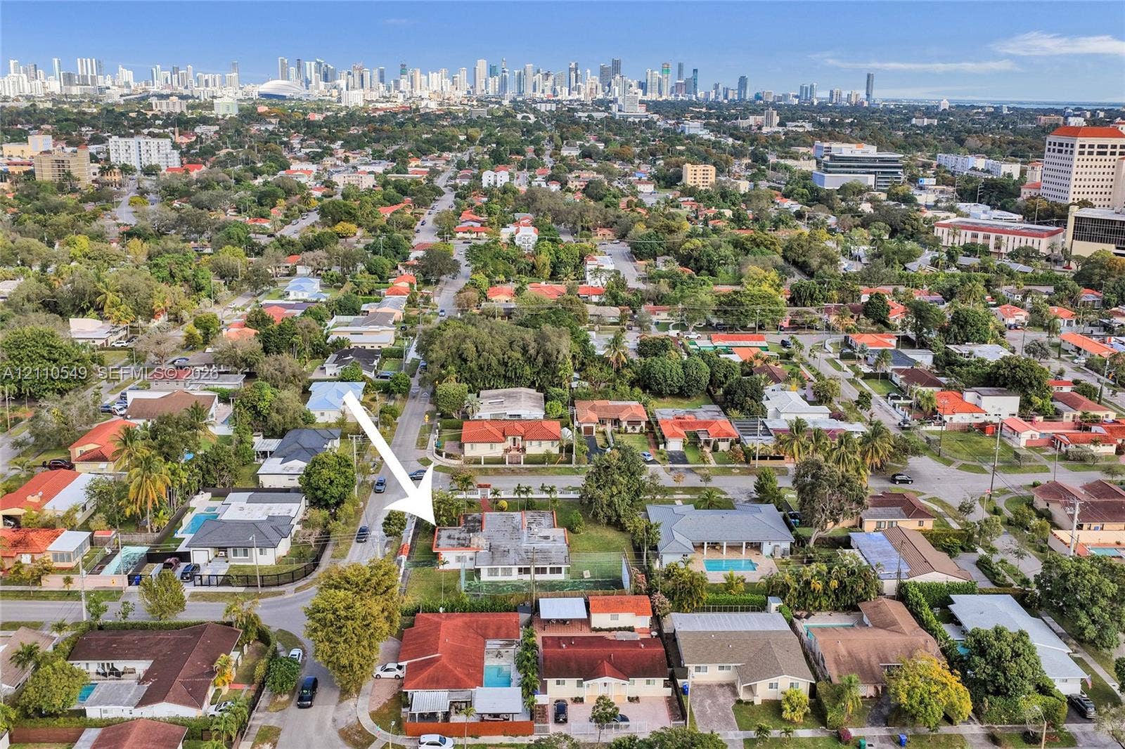 500 SW 39th Court, Miami, FL 33134 Aerial perspective of residential property featuring a flat-roof structure, expansive lot, and proximity to the urban skyline
