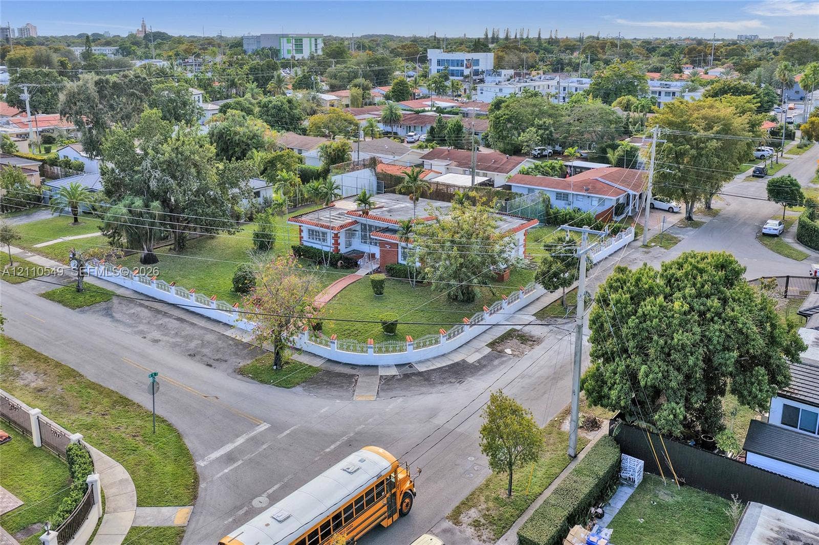500 SW 39th Court, Miami, FL 33134 Corner lot property featuring a masonry perimeter wall, mature landscaping, and an expansive lawn