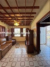 500 SW 39th Court, Miami, FL 33134 Grid-patterned ceiling feature with exposed wooden beams, tile flooring, and integrated ceiling fan