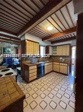 500 SW 39th Court, Miami, FL 33134 Kitchen featuring wood cabinetry, integrated built-in appliances, a tiled backsplash, exposed ceiling beams, and patterned tile flooring
