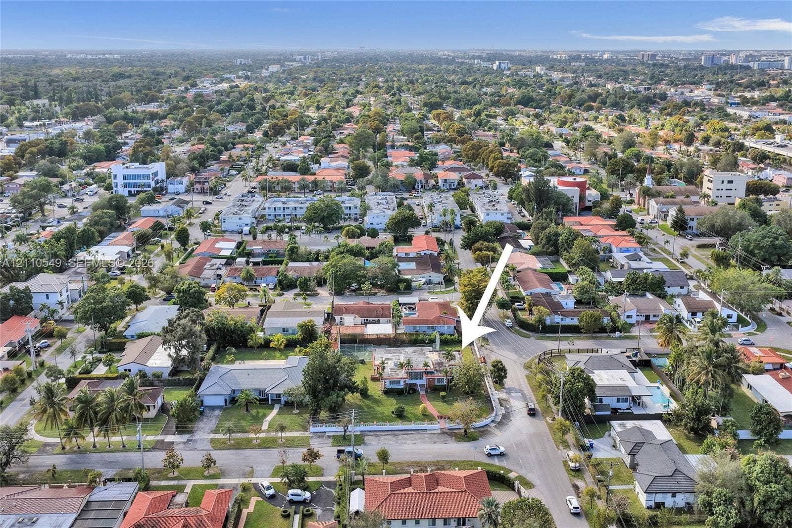 500 SW 39th Court, Miami, FL 33134 Aerial perspective featuring a corner lot with mature landscaping, fenced perimeter, and street access