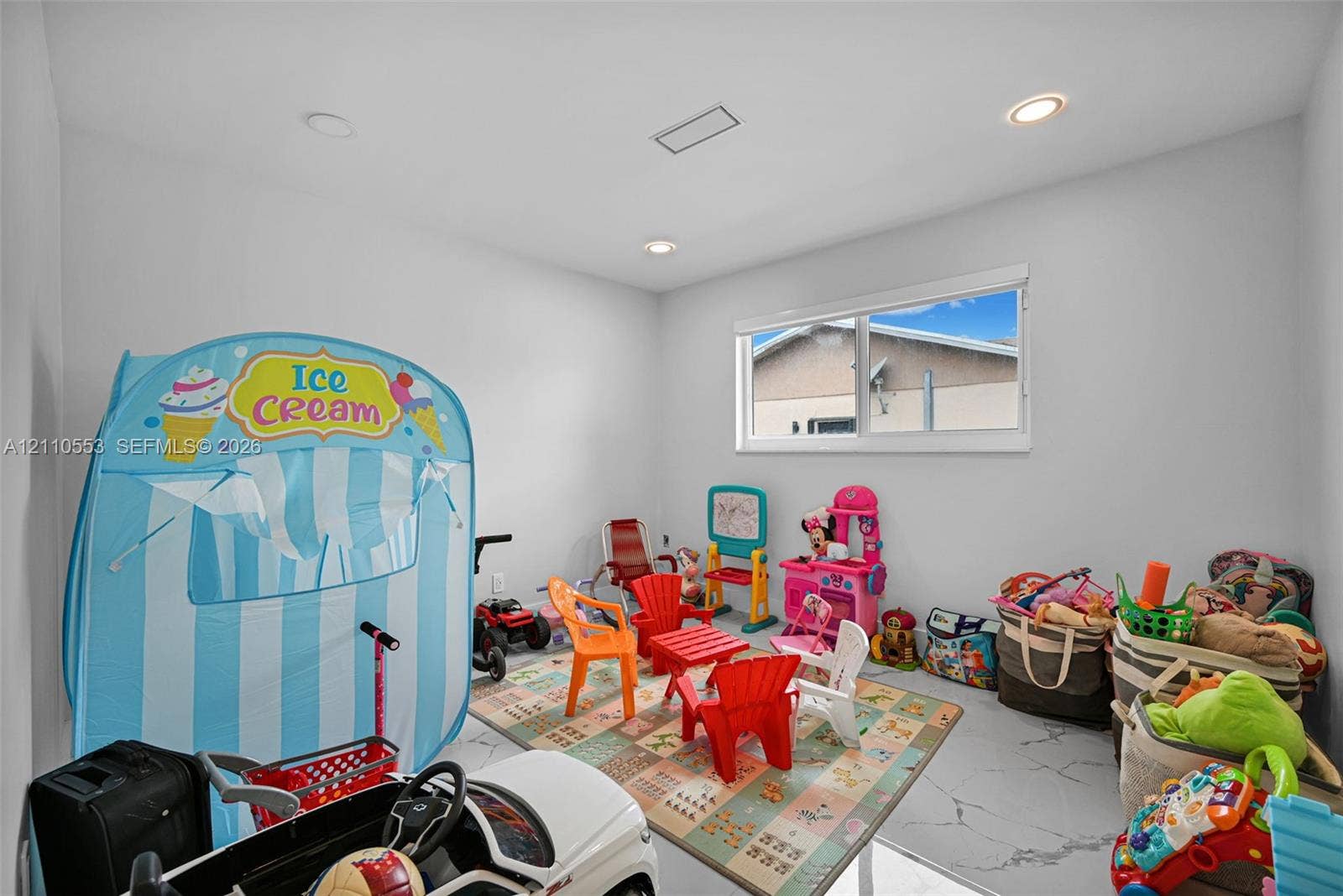 16611 SW 108th Court, Miami, FL 33157 Neutral-toned interior room featuring recessed lighting, a horizontal sliding window, and large-format tile flooring