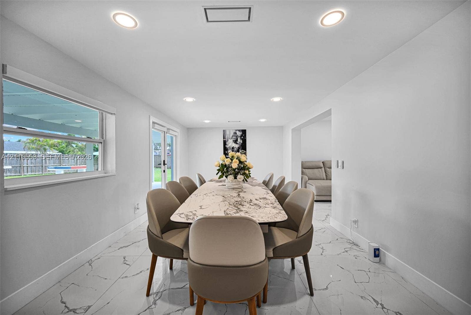 16611 SW 108th Court, Miami, FL 33157 Large-format stone-look flooring, recessed ceiling lighting, and glass paneled doors providing exterior access