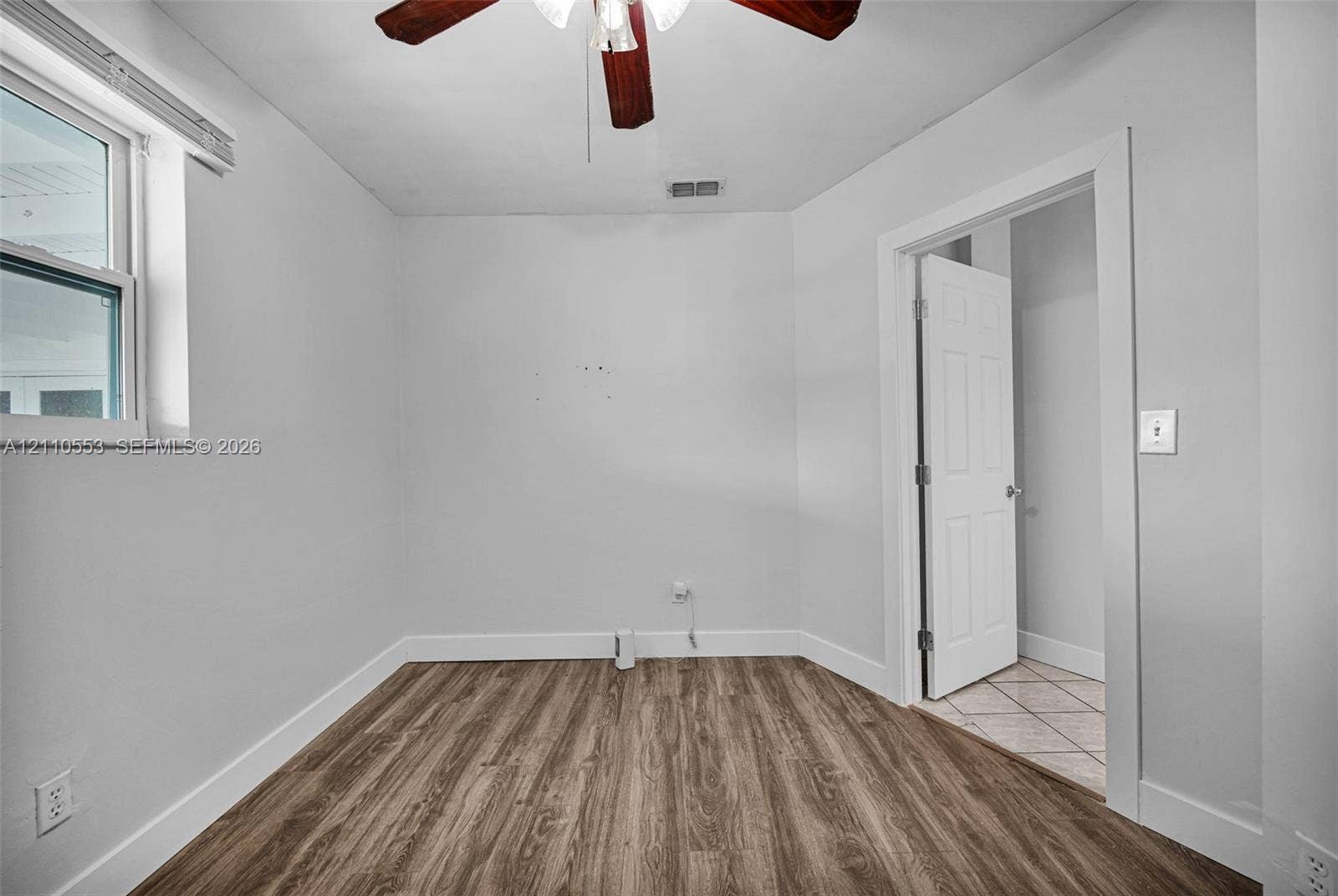 16611 SW 108th Court, Miami, FL 33157 Room featuring wood-finish flooring, a ceiling fan, and a neutral color palette
