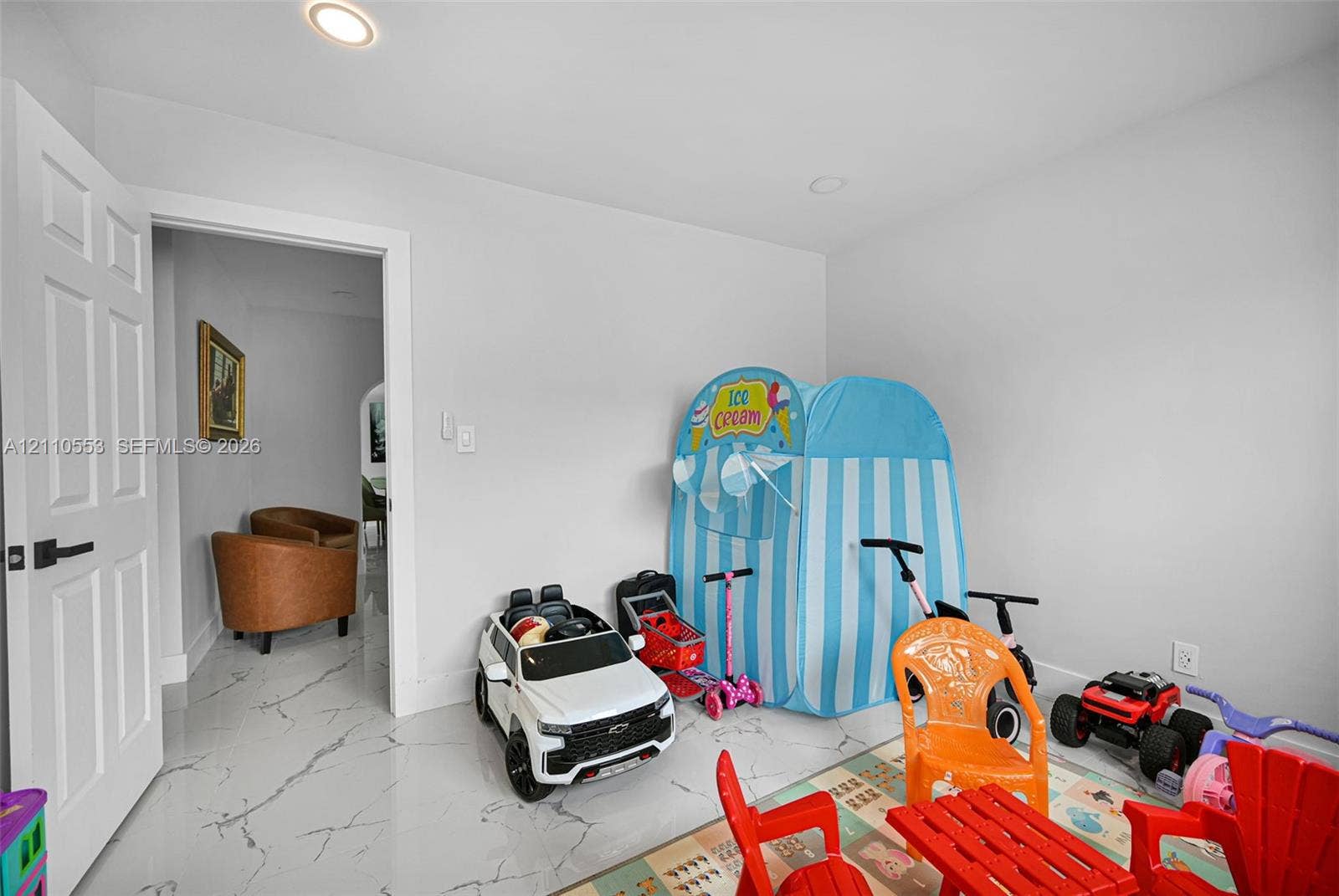 16611 SW 108th Court, Miami, FL 33157 Room featuring neutral-toned walls, recessed lighting, polished stone-finish tile flooring, and a multi-panel door with matte black hardware