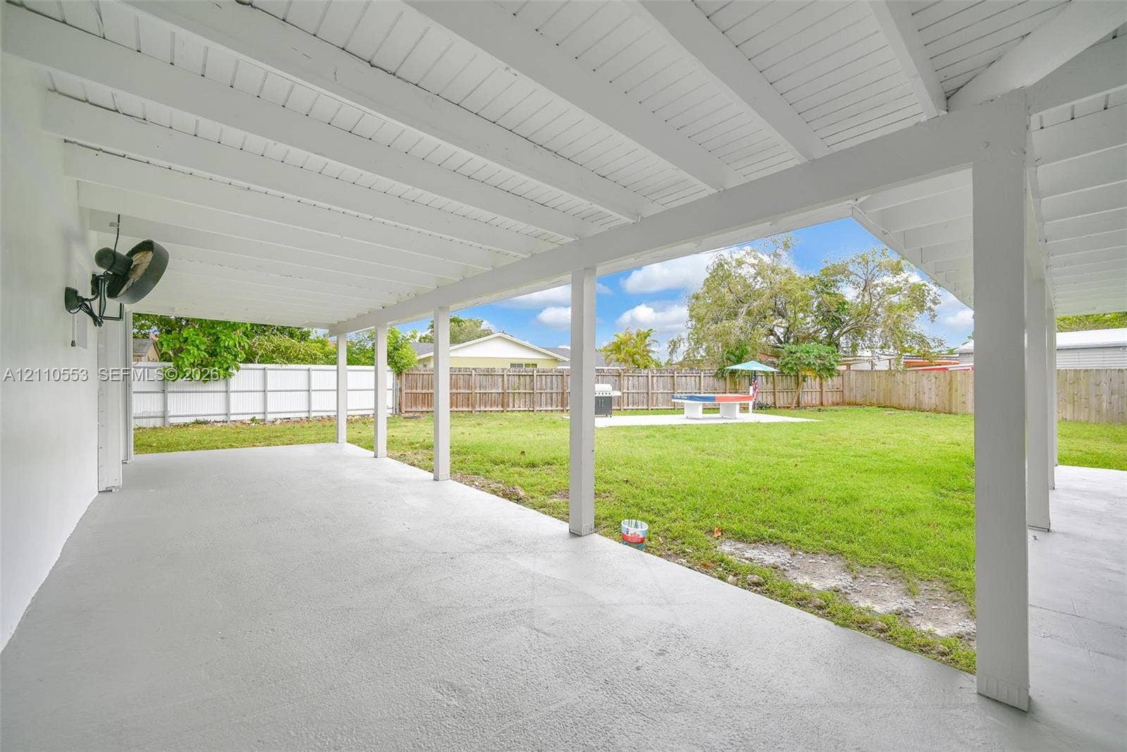 16611 SW 108th Court, Miami, FL 33157 Covered patio featuring an exposed-beam ceiling, concrete flooring, and a fenced backyard
