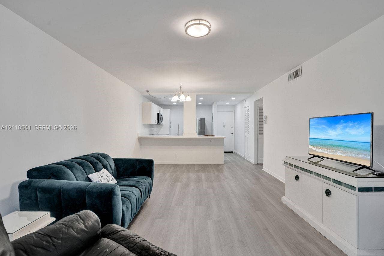 7950 W Mcnab Road, #222, Tamarac, FL 33321 Open floor plan featuring wood-finish flooring, recessed ceiling lighting, and a kitchen peninsula with a breakfast bar