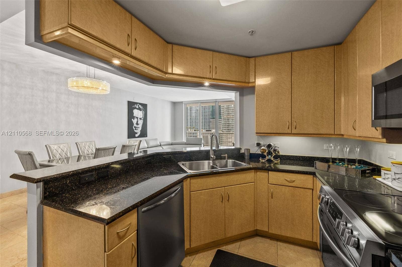 801 Brickell Key Boulevard, #2006, Miami, FL 33131 Kitchen featuring light-finish cabinetry, dark stone countertops, stainless steel appliances, double-basin undermount sink, and tile flooring