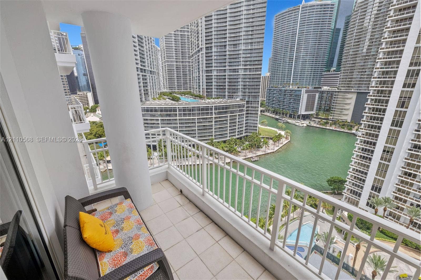 801 Brickell Key Boulevard, #2006, Miami, FL 33131 Covered balcony with white tile flooring, structural pillar, and white metal railing