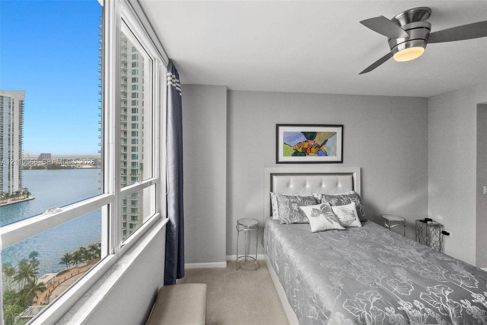 801 Brickell Key Boulevard, #2006, Miami, FL 33131 Floor-to-ceiling windows, water-facing exposure, neutral wall palette, and ceiling-mounted light fixture with fan