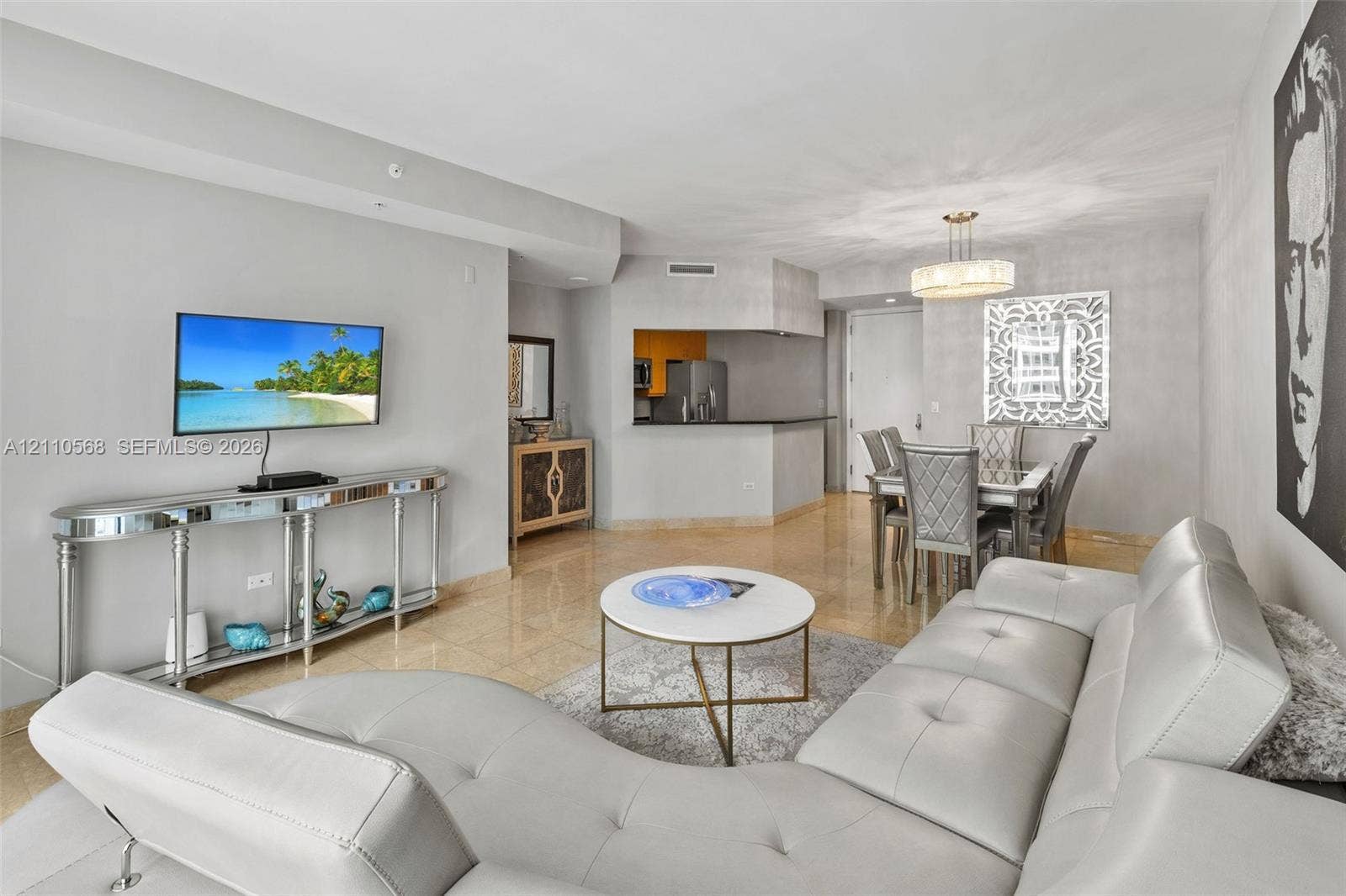 801 Brickell Key Boulevard, #2006, Miami, FL 33131 Open-concept interior featuring large-format stone flooring, neutral wall tones, and a pass-through kitchen counter
