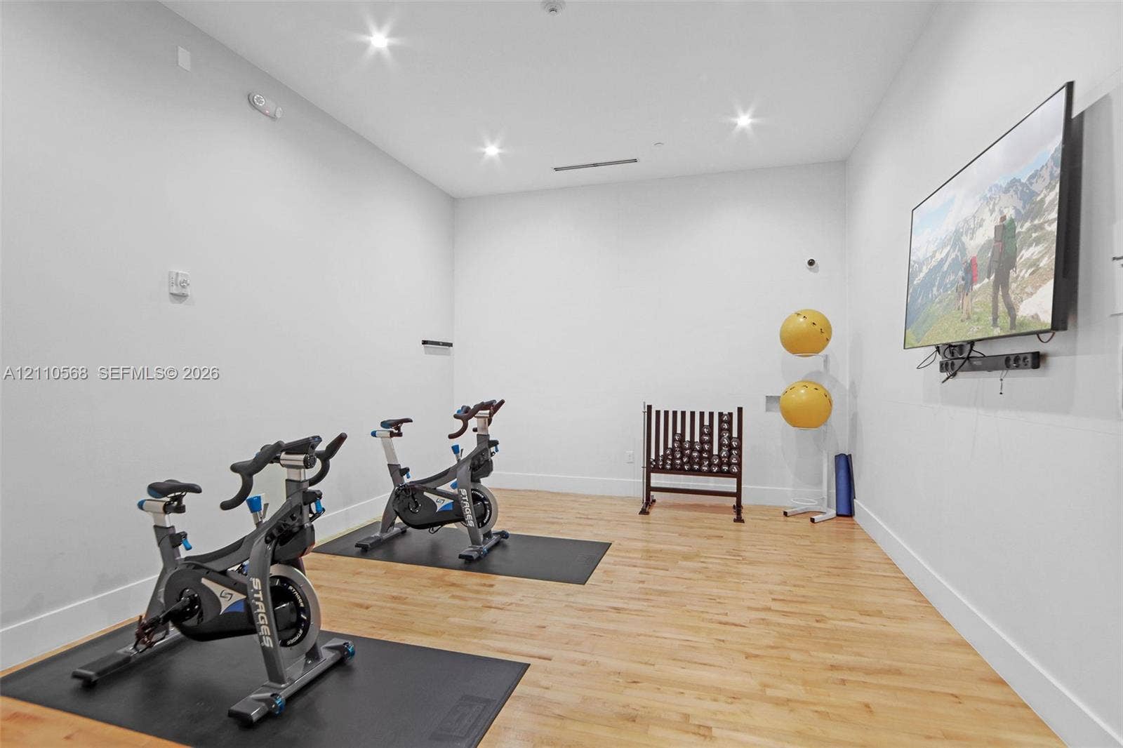 801 Brickell Key Boulevard, #2006, Miami, FL 33131 Interior space featuring light-toned wood-finish flooring, recessed ceiling lighting, and a wall-mounted display screen