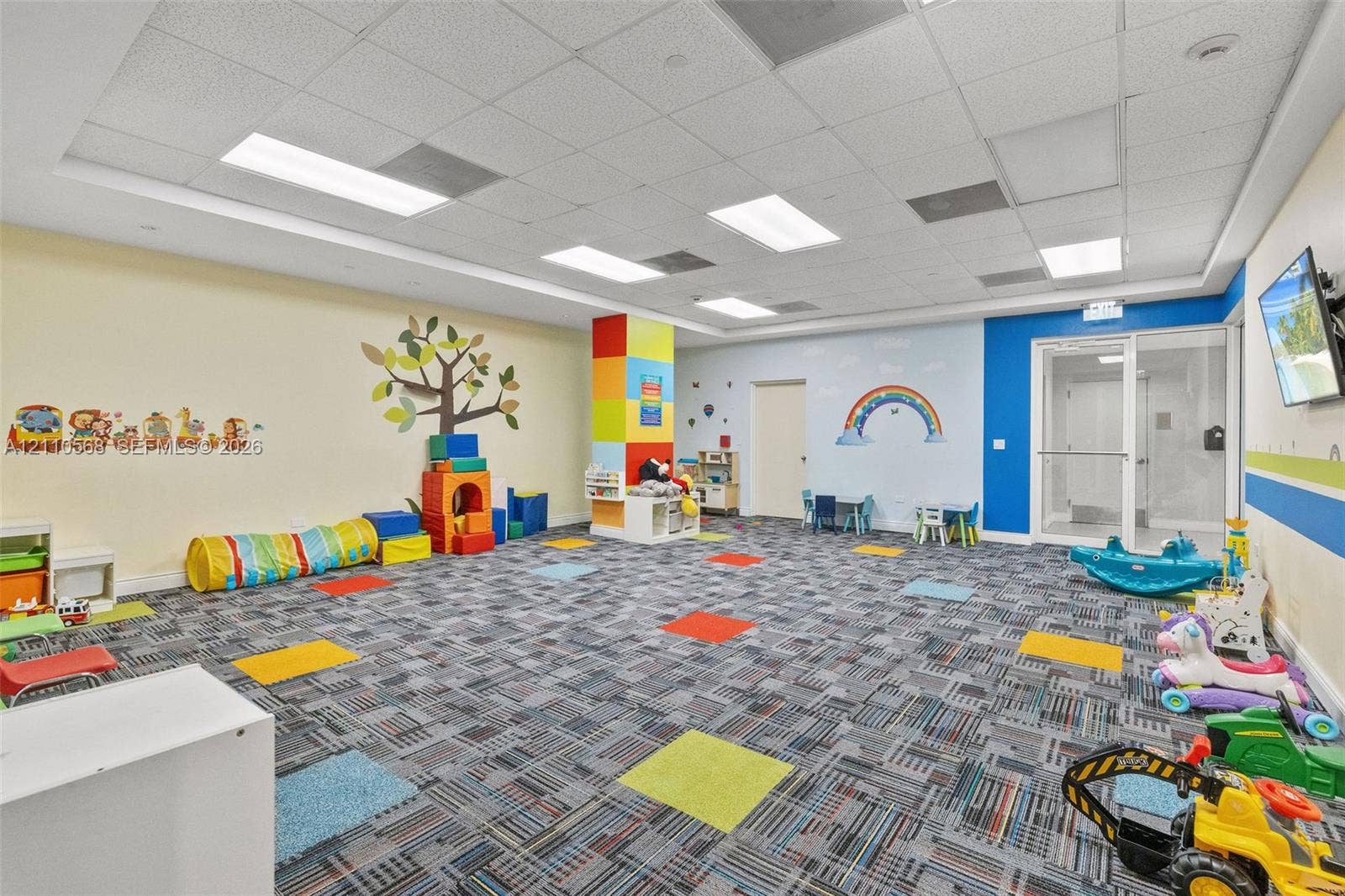 801 Brickell Key Boulevard, #2006, Miami, FL 33131 Multi-purpose room featuring a drop ceiling with recessed lighting, patterned carpet tiles, and glass entry doors