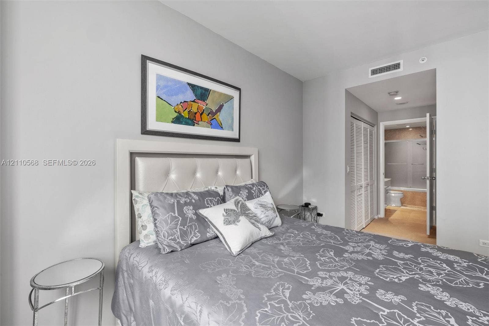 801 Brickell Key Boulevard, #2006, Miami, FL 33131 Neutral-toned walls with louvered closet doors