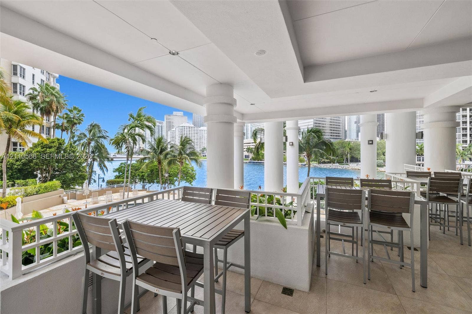 801 Brickell Key Boulevard, #2006, Miami, FL 33131 Covered terrace featuring stone tile flooring, structural columns, and integrated recessed lighting